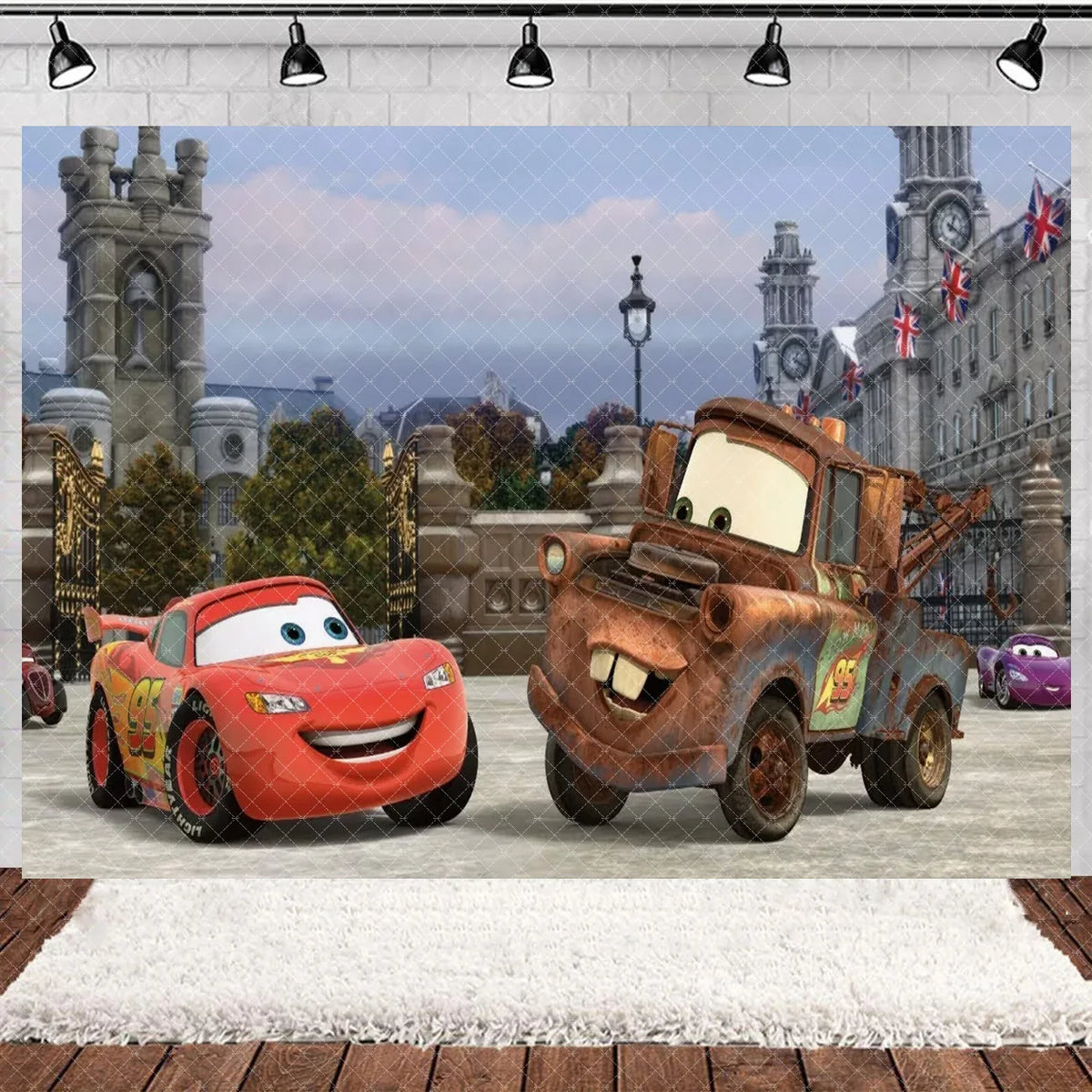 A die-cast model of a red race car and a brown vintage car set against a historical cityscape backdrop.