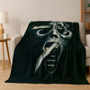 A dark green flannel throw blanket featuring a stylized, menacing mask face design.