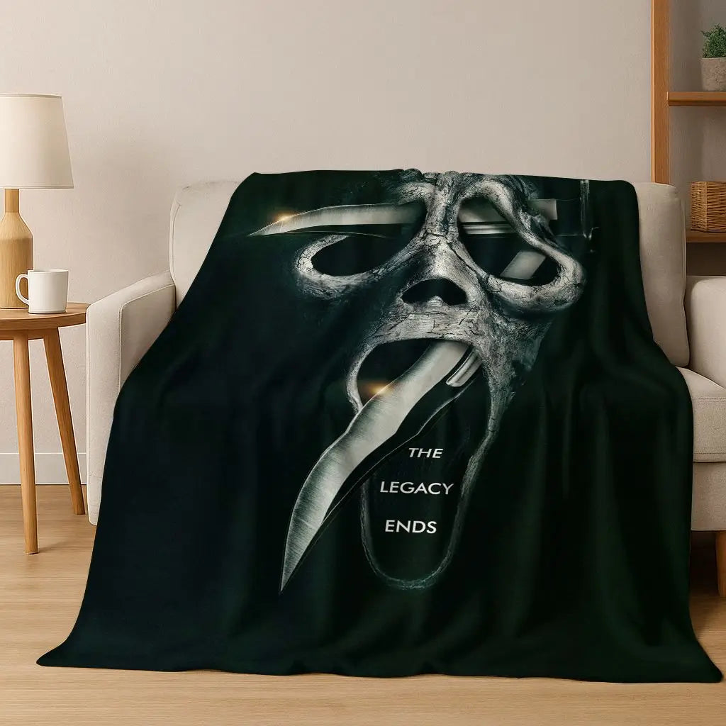 A dark green flannel throw blanket featuring a stylized, menacing mask face design.