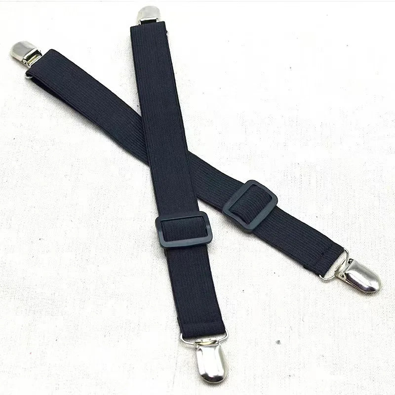 A black adjustable crisscross bed sheet clip with silver metal ends.