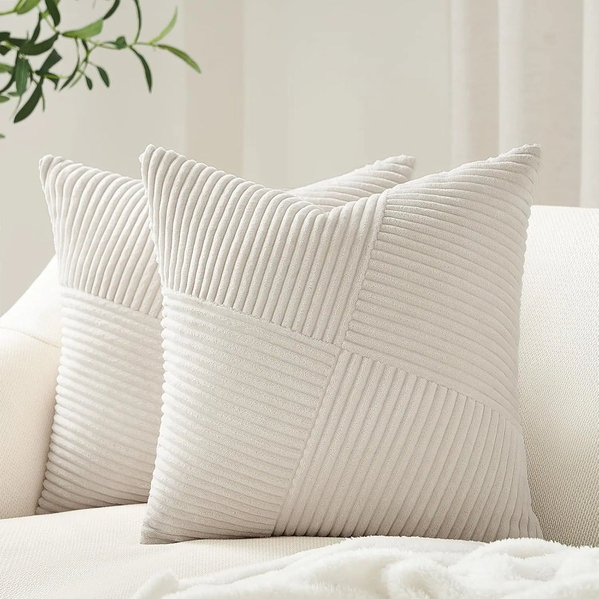 A white textured corduroy throw pillow cover with a diagonal quilted pattern.