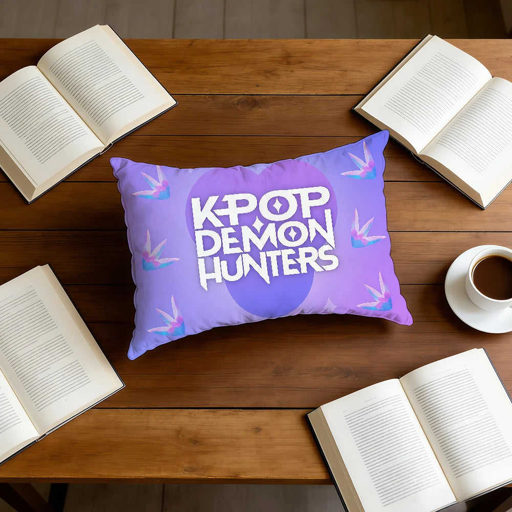 A purple cushion cover featuring the text KPOP DEMON HUNTERS on a light purple background placed on a wooden table.