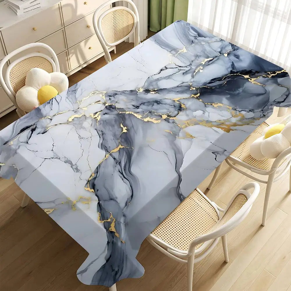 A marble-patterned tablecloth featuring gray and white marble with gold veining on a wooden table.