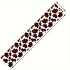 A brown and white cow print linen table runner for rustic kitchen decor.