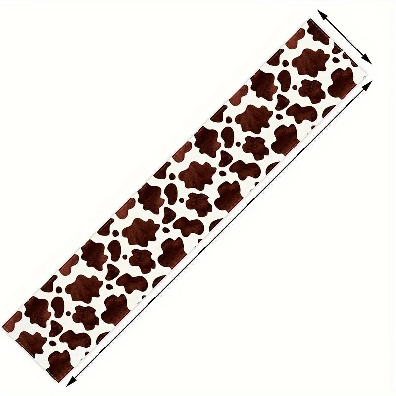 A brown and white cow print linen table runner for rustic kitchen decor.