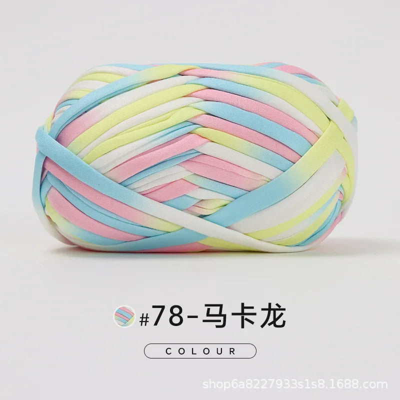 A ball of hand-dyed fabric strip yarn featuring pastel pink, blue, and yellow stripes.