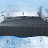 A dark gray cooling fiber blanket is displayed on a bed, highlighting features like ultra cooling, skin-friendly, silky and d