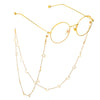 Gold-toned eyeglasses with thin gold chain necklaces featuring star and moon charms