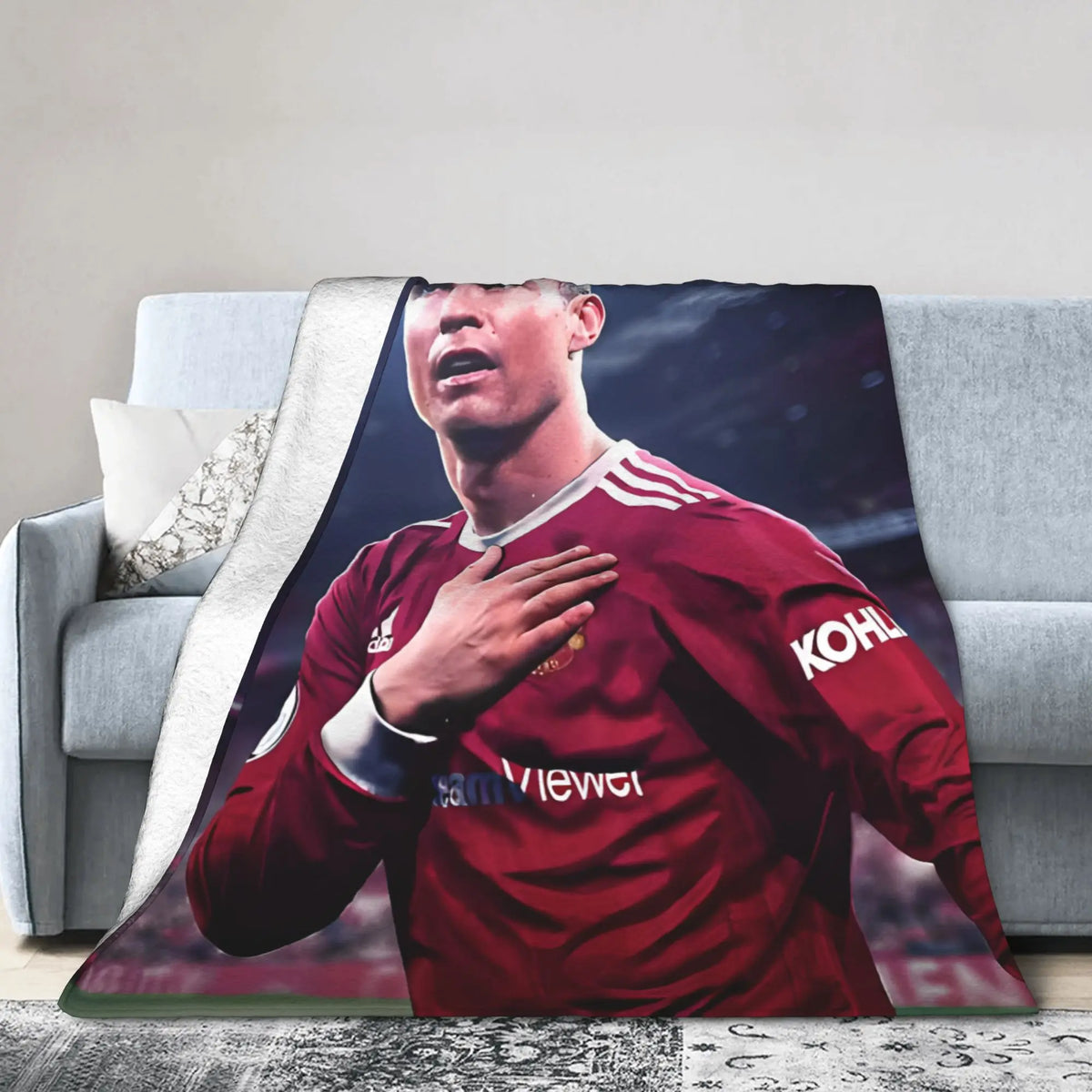 A football player wearing a red jersey is featured on a throw blanket.