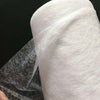 Roll of white double-sided iron-on adhesive tape used for garment repair
