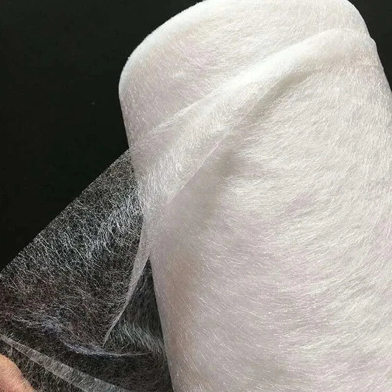 Roll of white double-sided iron-on adhesive tape used for garment repair