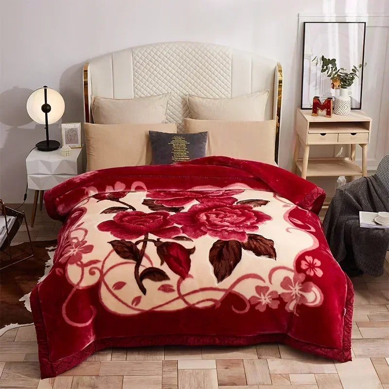 A deep red weighted blanket with a floral pattern is displayed on a bed in a bright room.