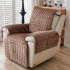 A beige quilted stretch recliner cover with brown fabric and storage pockets sitting on a wooden shelf.