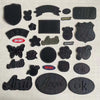 A collection of black embroidered leather patches featuring various designs like a shield, text, and symbols.