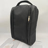 A black portable shoe carrier bag with a padded design and zipper visible against a light background.