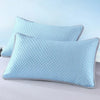 Light blue quilted ice silk cooling pillowcase resting on a white surface.