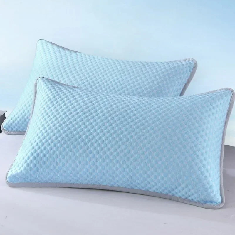 Light blue quilted ice silk cooling pillowcase resting on a white surface.