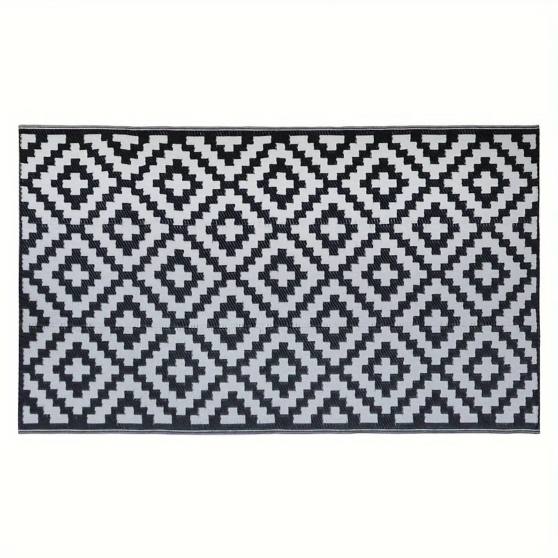 A black and white geometric pattern rug with diamond shapes.