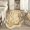 Irregular plush area rug with swirling gold and beige patterns on a wooden floor.