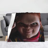 A flannel throw blanket featuring a close-up image of Chucky from the horror movie franchise.
