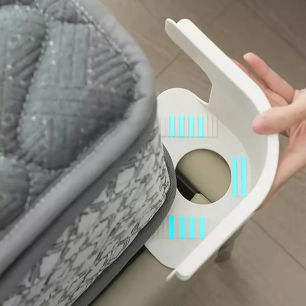A hand is holding a white clip designed to tighten the corner of a bedsheet, shown next to a gray quilted fabric.