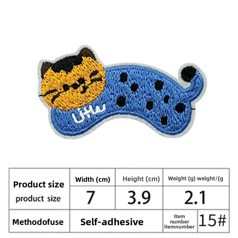 Two embroidered iron-on patches shaped like cats, one yellow and one blue, on a white background.