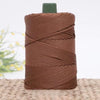A spool of brown 3mm ice rope crochet yarn with a green plastic core lying on a woven mat.