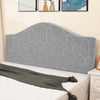 A gray soft elastic headboard cover is displayed on a white bed, with a knitted throw draped across it.