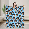 A blue throw blanket featuring a pattern of anime characters with funny expressions.