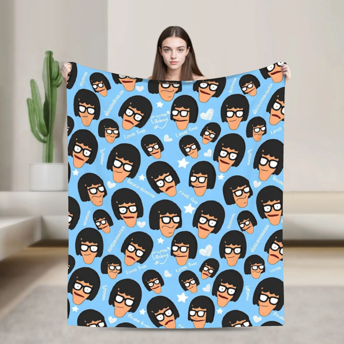 A blue throw blanket featuring a pattern of anime characters with funny expressions.
