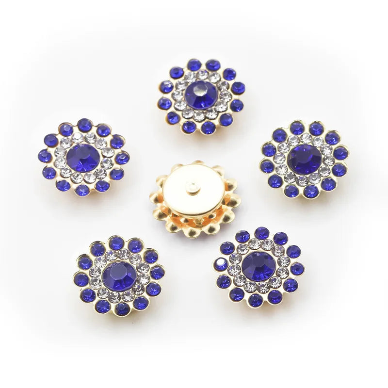 Five clusters of round blue and clear rhinestones on a gold-toned base.