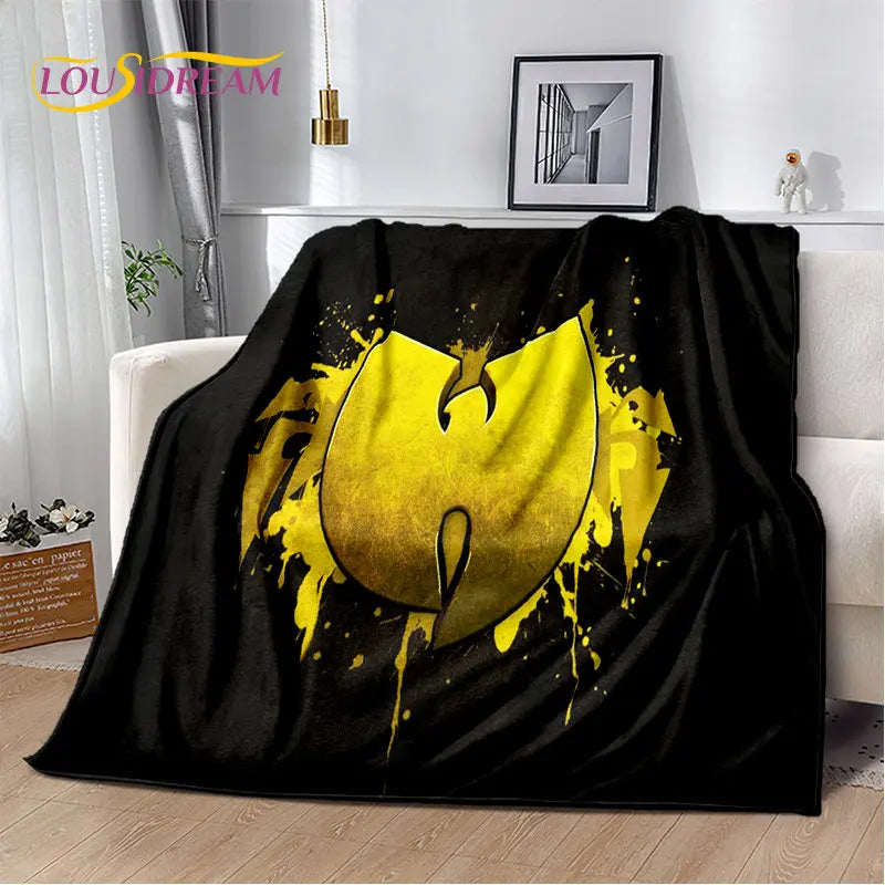 A black flannel throw blanket featuring a yellow, dripping bat design.