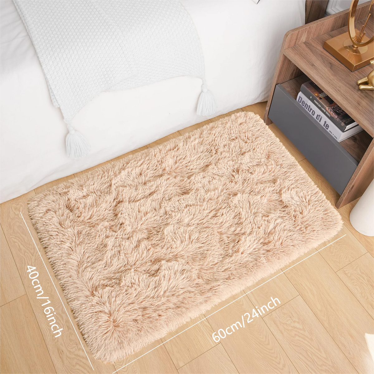 A rectangular cream tie-dye shaggy rug placed on a light wooden floor next to a bed and a wooden shelf.