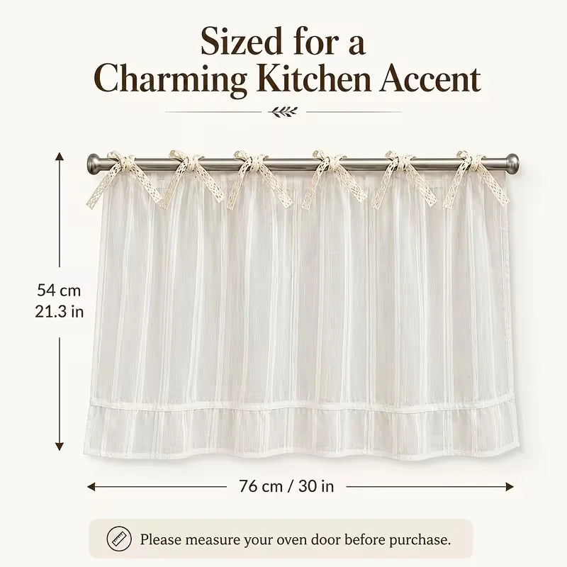 Cream sheer kitchen curtain featuring a ruffled skirt and ribbon ties for an oven door.