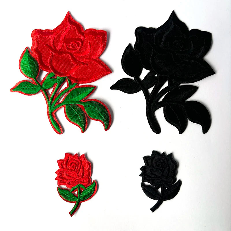 Four embroidered rose flower patches in red and black velvet fabric.