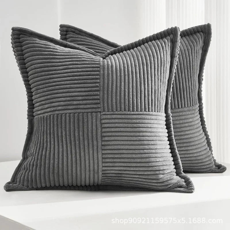 A gray striped corduroy lumbar support pillow cushion shown in a close-up view.