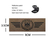 A rectangular brown embroidered patch featuring a black eagle shield design and wings.