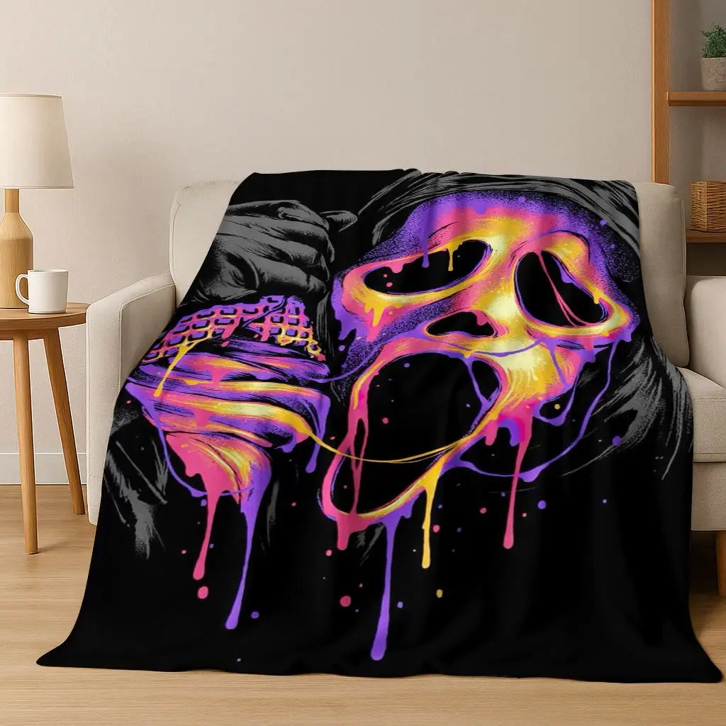 A black flannel throw blanket featuring a vibrant, dripping horror character design in neon purple and yellow.