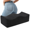 A person is shown wearing a black ergonomic seat cushion for tailbone relief and hip support.