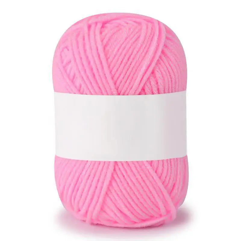 A ball of bright pink soft milk cotton knitting yarn