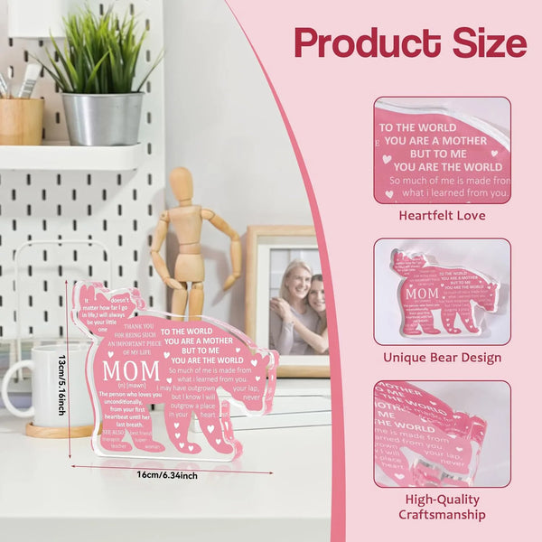 A pink personalized bear plaque keepsake with a heart design displayed on a white surface.