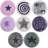 A set of nine tinplate pin brooches featuring various designs including stars, spirals, and animals in purple, black, and sil