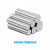 A stack of 50 silver-colored, corrugated magnetic fridge magnets measuring 8x3mm.