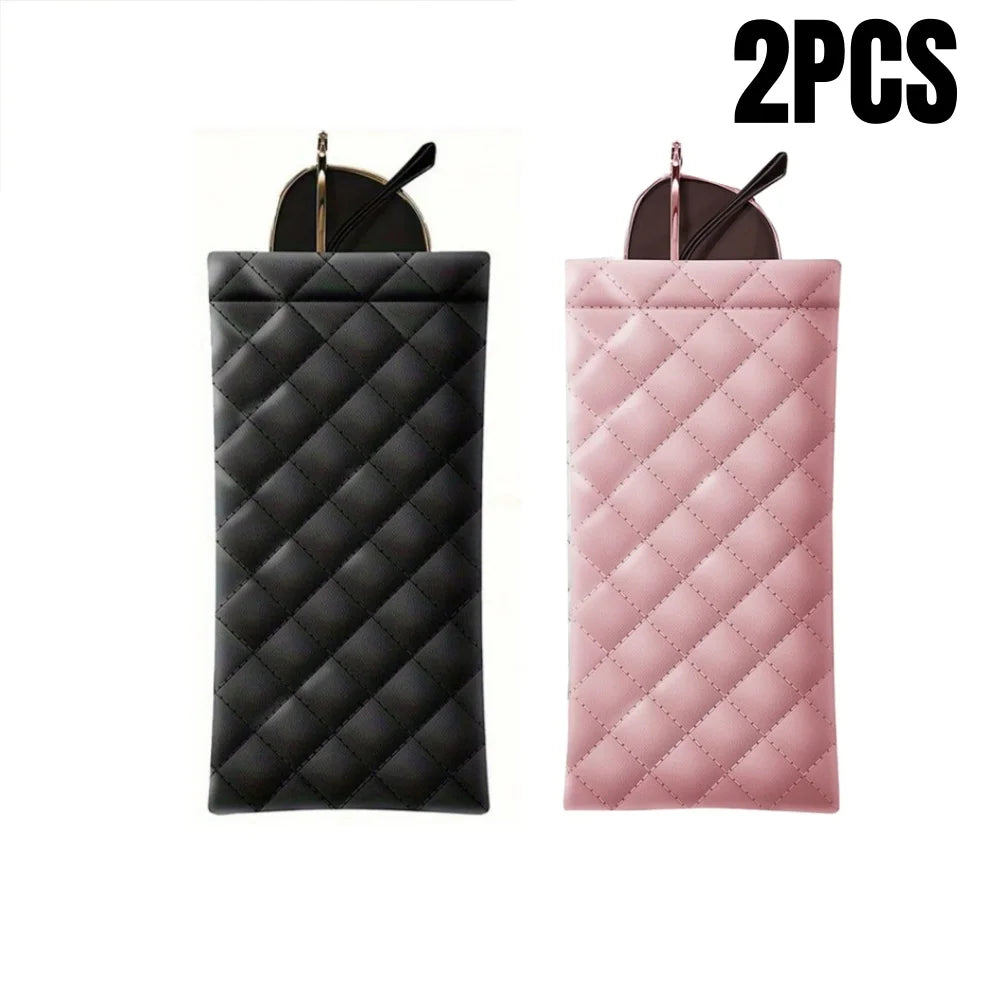 A pair of pink and black quilted PU leather eyeglass cases with cleaning cloths.