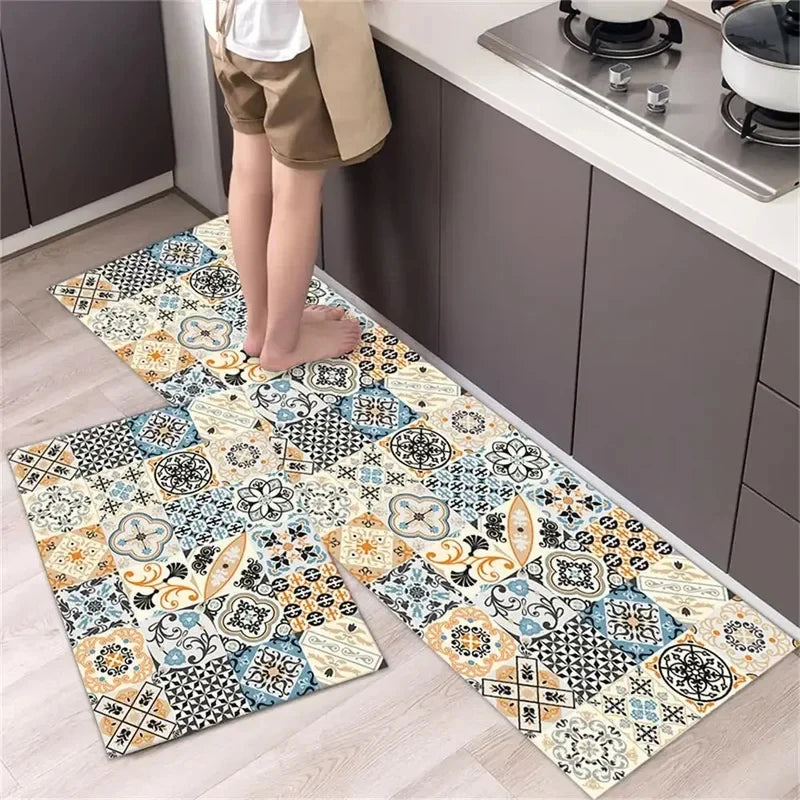 A rectangular diamond print non-slip kitchen rug set featuring blue, beige, and black patterns on a light wood floor.