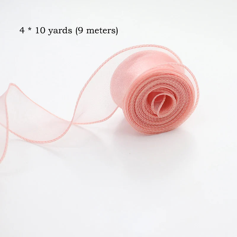 Roll of pink silky organza ribbon measuring 4 times 10 yards or 9 meters for crafting and wrapping