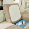 A beige jacquard sofa slipcover with a white back cushion and blue accent cushion.