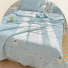 Light blue quilt blanket with a pastoral print featuring clouds, stars, and cute animal motifs on a bed.