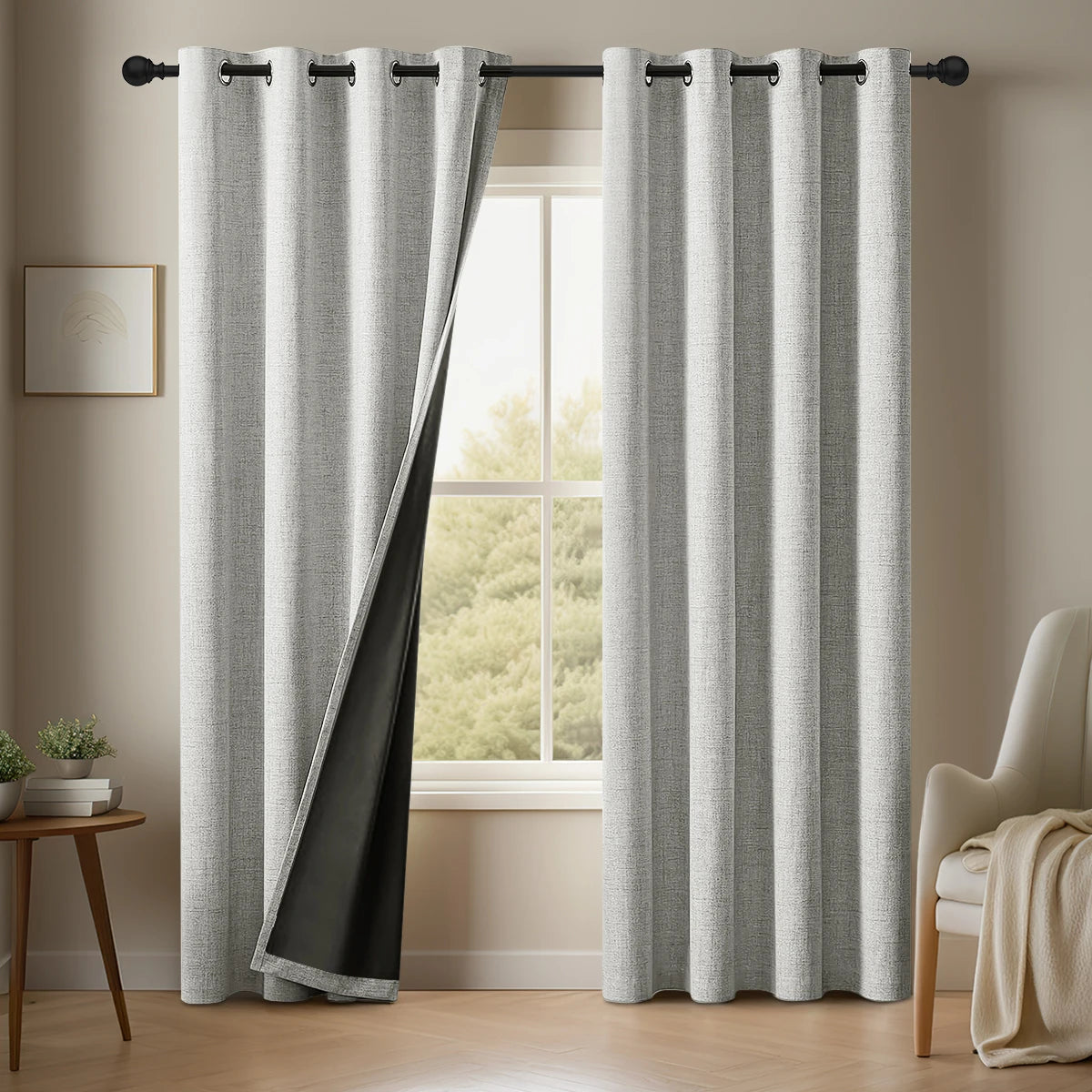 Gray linen blackout curtains hanging in a window frame
