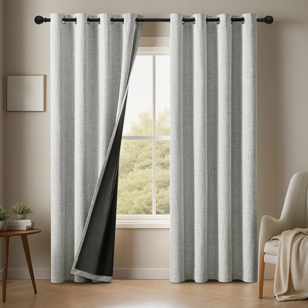 Gray linen blackout curtains hanging in a window frame